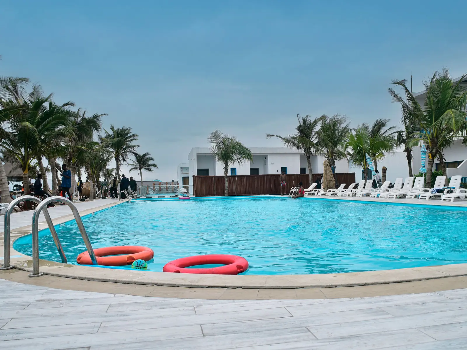 A resort pool with loungers in the shade
