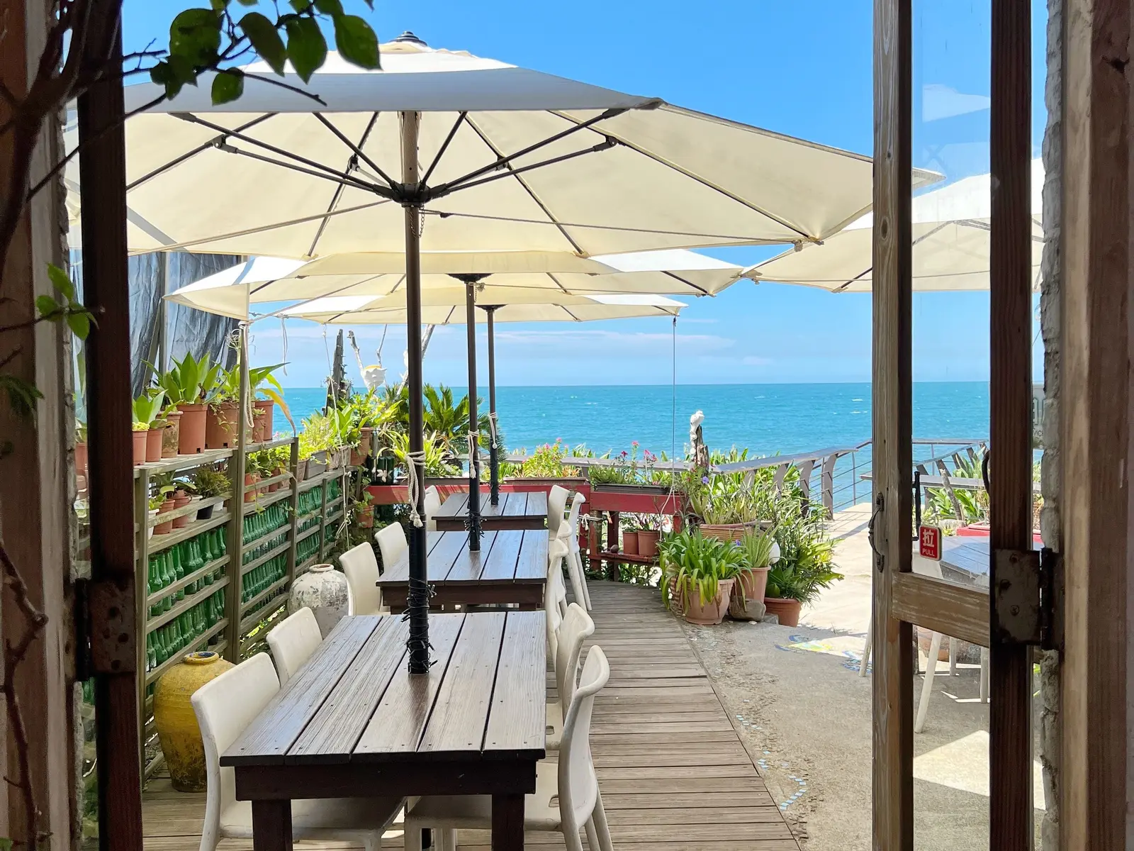 Tables set on a seaside terrace overlooking the water